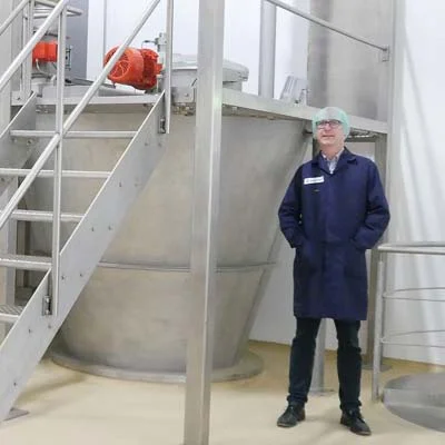 Thomas Weber, Head of Process Engineering at Martin Bauer, next to a Hosokawa Micron mixer